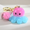 Porte-clés poulpe lumineux rose et bleu avec clochette sur fond blanc épuré - Style Cloche [Rose]