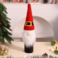 Detail of knitted Christmas gnome wine bottle cover with red pointed hat and faux fur - Belt Style
