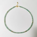 Detail of light green natural stone beaded necklace with gold spacers and lobster clasp - Light Green Aventurine Color