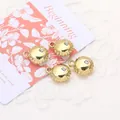 Close-up of golden mini round pendant charms with inlaid zircon for DIY jewelry making - Round / Gold