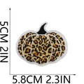 Macro detail of pumpkin embroidery patch with leopard print pattern and size markings - No. 48