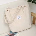 Detail of cream corduroy tote bag showing vintage metal ring and fabric brand label - Off-white