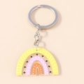 Colorful rainbow acrylic keychain with geometric patterns and metallic gold keyring - Yellow Star Rainbow