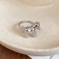 Close-up of a silver horse ring with a sparkling heart-shaped zircon on a ceramic tray - Silver Heart Pony Style