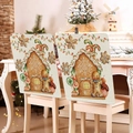 Detail view of gingerbread house and snow Christmas chair covers in a festive dining room - Classic Gingerbread Snow Scene (YT05-9)