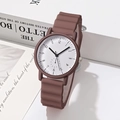 Brown silicone strap quartz watch with minimalist round dial on a stylish white setup - Coffee
