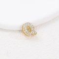Macro shot of bubble letter Q gold pendant with pave-set zircon stones and tiny stones - Q (Single Pendant)
