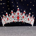 Macro shot of silver bridal crown featuring red crystal gemstones and intricate rhinestone detail - Silver Red Crystal