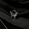 Macro shot of a silver butterfly ring with polished finish on black silk fabric - Adjustable Open / Silver Polished 3D Butterfly (JZ4304)