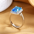 Macro shot of rectangular aquamarine zircon ring with silver halo and adjustable band - Silver (Aquamarine Stone)