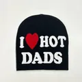 Flat lay of black knit beanie with white I Heart Hot Dads text and red heart - Dads Style / Black