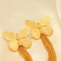Macro detail of gold butterfly earrings featuring elegant metal chain tassels and high gloss - Gold Butterfly Tassel Earrings