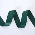 Detailed view of dark green satin ribbon with metallic gold elk and snowflake prints - Wide Solid Christmas Green Ribbon (4cm Width 5m Length)