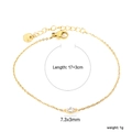 Vista macro dettagliata di un bracciale dorato con zircone e indicazioni delle misure - Zircone Marquise