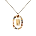 Detail of gold necklace with oval pendant featuring a letter W and colorful zircon stones - Letter W