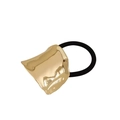 Detail of minimalist hair tie with textured gold wavy metal plate on black elastic band - Cloud