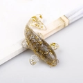 Transparent resin koi fish figurine with embedded gold foil flakes for office desk decor - Labradorite