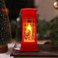 Close-up of red Christmas telephone booth lantern with Santa Claus and warm LED lighting - Red Santa Claus