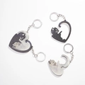 Detail of interlocking heart-shaped cat keychains in black and silver metallic finish - Heart Cat