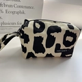 Detail of canvas pencil case with black cow print pattern and stylish handle strap - Beige Leopard/Cow Print (Large)