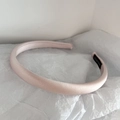 Detail of pink satin padded headband with hand made label on white tissue background - Light Pink