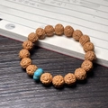 Brown bodhi seed bracelet with cat claw texture and a turquoise spacer bead - Vajra (Turquoise Pumpkin)