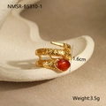 Detail view of a gold snake ring with a red oval gemstone and textured metal surface - Ring-Wrap-Red Zircon