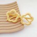 Bright yellow wave flower-shaped kids sunglasses on a textured wooden tray - Single Frame / Yellow
