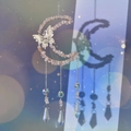 Detail of moon-shaped suncatcher with pink crystals and butterfly ornament in soft light - Rose Quartz