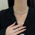Elegant double-layer pearl necklace and crystal ring on model in black suit - Double Layer High Luster Pearl Zirconia Necklace