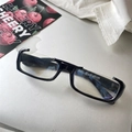 Detail of black rectangular anti-radiation glasses on a silver laptop surface - Half Frame Subculture / Black