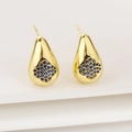 Detailed close-up of golden teardrop earrings with a blue zircon four-leaf clover motif - Dark Blue