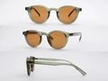 Drei Ansichten einer runden Retro-Sonnenbrille in Transparent-Grün mit orangefarbenem Glas - Bohnenpaste Grüner Rahmen Orange Gläser