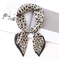 Classic cream leopard print satin skinny scarf shown as a stylish hair tie or bag accessory - Stone Leopard-Black Beige