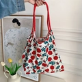 Detail of floral tote bag with red rose prints and thick red rope handles - All-over Rose