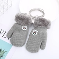 Detailed close-up of grey knitted toddler gloves with plush cuffs and a hanging neck string - 1-4 Years / Gray