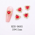 Macro detail of red heart nail art gems with gold frame and small rhinestones - Luxury Hollow Heart Nail Art Charm (9685)