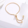 Adjustable gold-plated snake chain bracelet with sliding clasp and bead details - 25cm / Gold