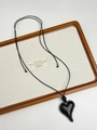 Close-up of black resin heart pendant necklace with adjustable woven rope on wooden tray - Modern Melted Heart (XL1377A)