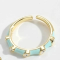 Macro detail of gold-plated Evil Eye ring featuring light blue enamel and adjustable band - Adjustable Open / Light Blue