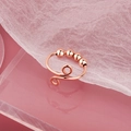 Rose gold spinner ring with four sliding beads for stress relief on pink background - Adjustable Open / Sliding Beads Style (NJ247) / Rose Gold