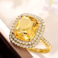 Elegant gold ring featuring a large square yellow gemstone with micro-pave diamond halo - Yellow + Gold