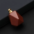 Macro shot of faceted goldstone perfume bottle pendant with a golden metal clasp - Gold Sandstone