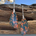 Bohemian teardrop turquoise earrings with silver metal hooks on natural wood background - Multi-color