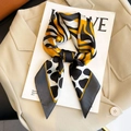 Silk-feel square scarf with yellow tiger and white cow animal prints tied in a bow - 102 Square Scarves / 65