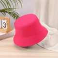 Detail view of a bright pink cotton bucket hat with a wide brim in a lifestyle setting - One Size / Plum Red