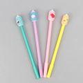 Set of four colorful neutral pens with cute silicone fruit toppers on gray background - Beverage Can Shaped Gel Pen