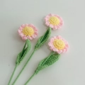 Macro shot of handmade crochet flowers with pink petals and yellow stamens on white - Single Finished Flower / Little Daisy (Pink)