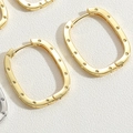Macro shot of gold-plated rectangular hoop earrings with dotted edge texture and clasp detail - Large / Gold