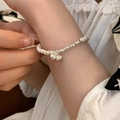 Elegant pearl and silver bead bracelet with lotus charms on a female wrist - Lotus Seed Artificial Pearl Style (SL1111)